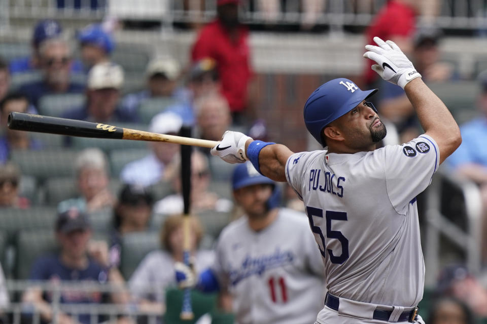 Los Angeles Dodgers first baseman Albert Pujols drives in a run with a base hit in the fourth inning of a baseball game against the Atlanta Braves Sunday, June 6, 2021, in Atlanta. (AP Photo/Brynn Anderson)