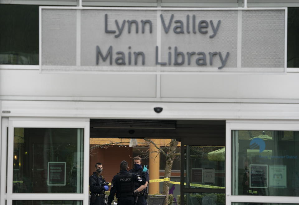 Members of the RCMP are seen outside of the Lynn Valley Library, in North Vancouver, British Columbia, Saturday, March 27, 2021. Police say multiple victims were stabbed inside and outside the library today. (Jonathan Hayward/The Canadian Press via AP)