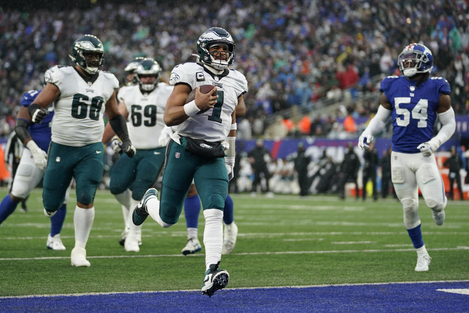 Philadelphia Eagles quarterback Jalen Hurts (1) scores a touchdown against the New York Giants during the third quarter of an NFL football game, Sunday, Dec. 11, 2022, in East Rutherford, N.J. (AP Photo/Bryan Woolston)