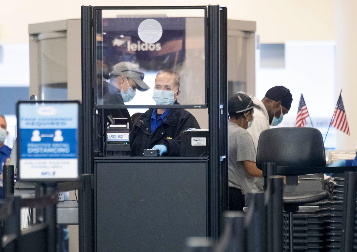 Transportation Security Administration agents screen passengers at Milwaukee Mitchell International Airport in Milwaukee. On Wednesday, Mitchell International announced it was adding CLEAR this year to help move passengers more quickly through the security process.