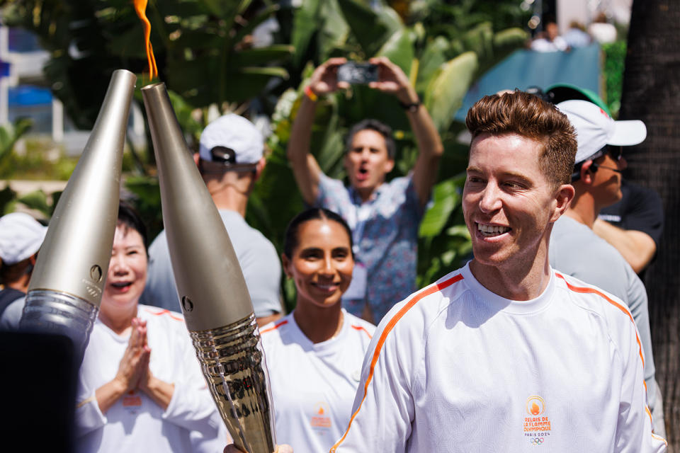 Shaun White carries the Olympic Torch in front of the Carlton Hotel during the Cannes Lions International Festival Of Creativity 2024