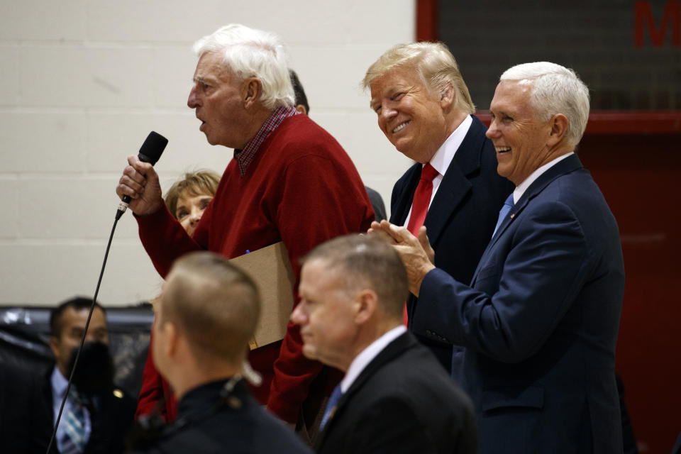 President Donald Trump and Vice President Mike Pence smile as former basketball coach Bob Knight speaks to an overflow crowd at a campaign rally at Southport High School, Friday, Nov. 2, 2018, in Indianapolis. (AP Photo/Evan Vucci)