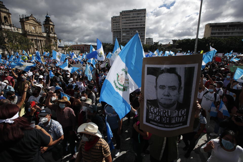 Protesters gather outside Congress in Guatemala City, Saturday, Nov. 21, 2020. Hundreds of protesters were protesting in various parts of the country Saturday against Guatemalan President Alejandro Giammattei and members of Congress for the approval of the 2021 budget that reduced funds for education, health and the fight for human rights. (AP Photo/Moises Castillo)