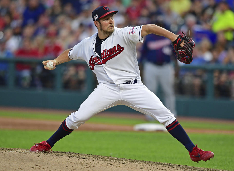 FILE - In this July 13, 2019, file photo, Cleveland Indians starting pitcher Trevor Bauer delivers in the sixth inning of a baseball game against the Minnesota Twins, in Cleveland. The Indians bulked up for the playoff race by trading temperamental starter Trevor Bauer before the deadline to Cincinnati in a three-team deal they hope can help them run down the Minnesota Twins. Cleveland, which trails the AL Central by three games but leads the wild-card race, sent Bauer to the Reds for slugger Yasiel Puig and left-hander Scott Moss. The Indians also acquired outfielder Franmil Reyes, lefty Logan Allen and infield prospect Victor Nova from the San Diego Padres, who acquired outfielder Taylor Trammel from the Reds. (AP Photo/David Dermer, File)