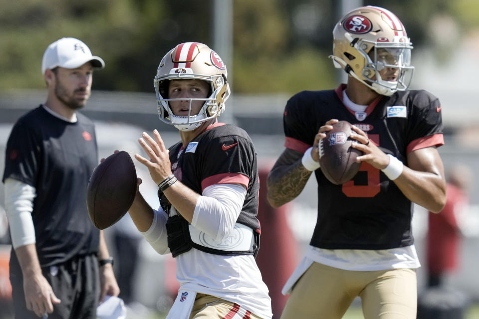 San Francisco 49ers quarterback Brock Purdy, left, takes part in a drill during NFL football training camp Friday, Aug. 4, 2023, in Santa Clara, Calif. (AP Photo/Godofredo A. Vásquez)