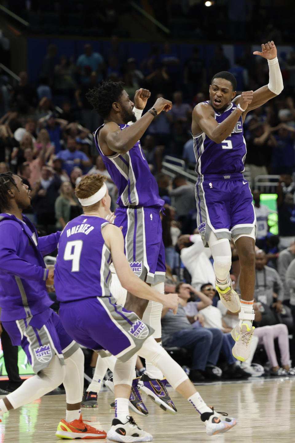 Sacramento Kings guard De'Aaron Fox (5) celebrates with his team after his 3-point final shot against the Orlando Magic during overtime of an NBA basketball game, Saturday, Nov. 5, 2022, in Orlando, Fla. (AP Photo/Kevin Kolczynski)