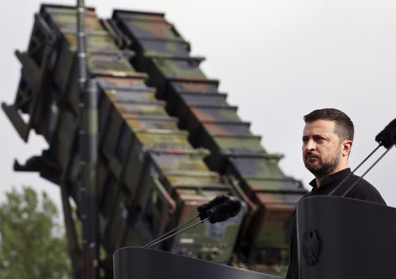 Ukraine's President Volodymyr Zelenskyy stands in front of a Patriot air defence missile system during a visit to a military training area in Germany.