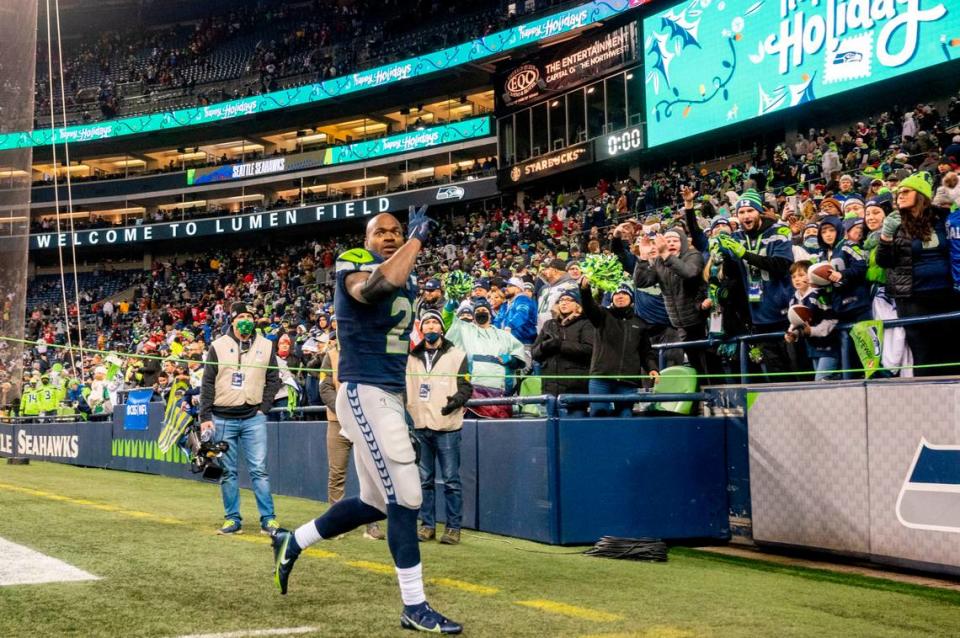 Seattle running back Adrian Peterson (21) waves to the fans as he walks off the field after the Seahawks beat San Francisco 49ers, 30-23 in an NFL game on Sunday at Lumen Field in Seattle.