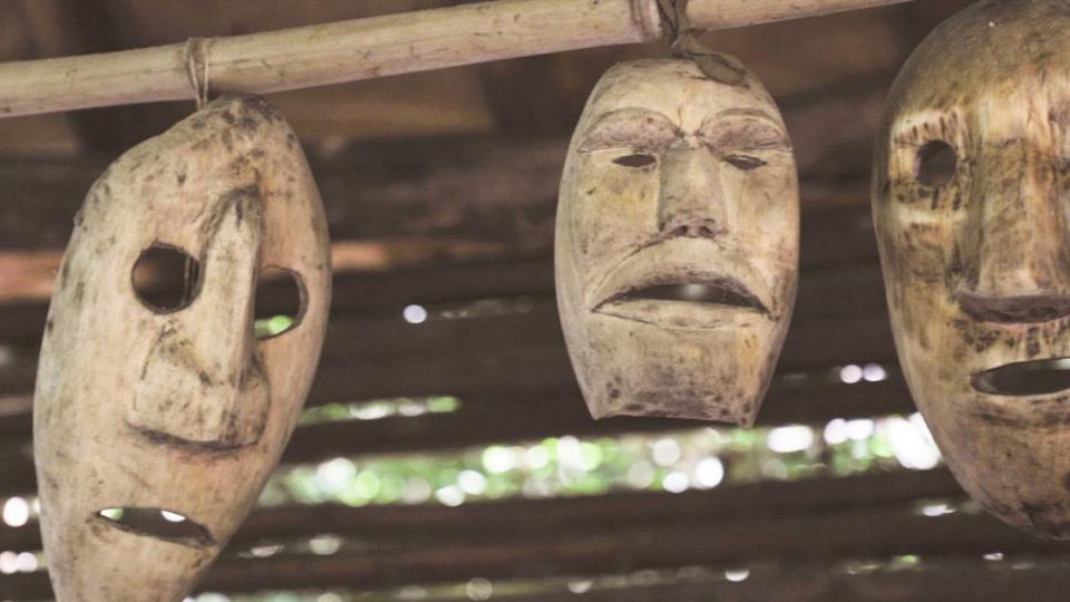 Traditional Cherokee masks hang on a wooden structure at the Oconaluftee Indian Village in Cherokee, N.C., on Saturday, July 1, 2023.