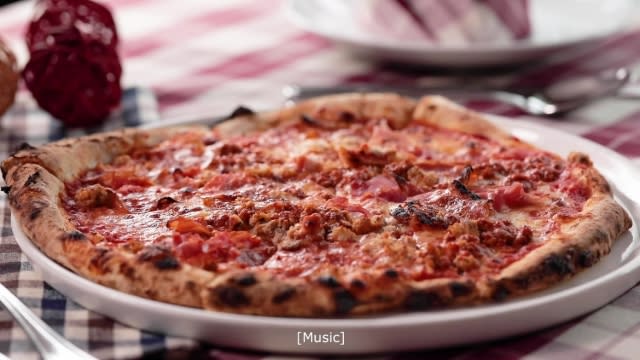 pizza with tomato sauce with ham, salami, sausage, cheese and ham