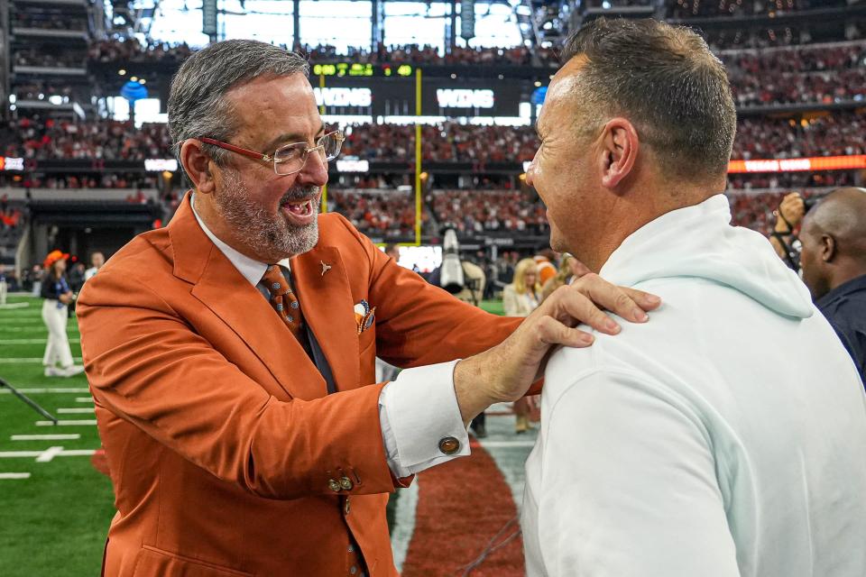 Texas athletic director Chris Del Conte, left, celebrates with head football coach Steve Sarkisian after the Longhorns' 49-21 win over Oklahoma State in the Big 12 championship game on Dec. 2 at AT&T Stadium in Arlington.
