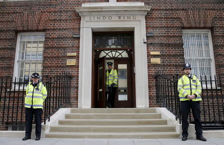 Police officers stand outside the entrance to the Lindo wing of St Mary's Hospital in central London May 2, 2015. REUTERS/Suzanne Plunkett