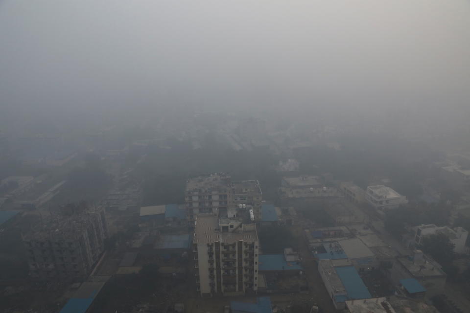 Residential buildings are seen shrouded in smog in Noida, India, November 5, 2021. REUTERS/Anushree Fadnavis