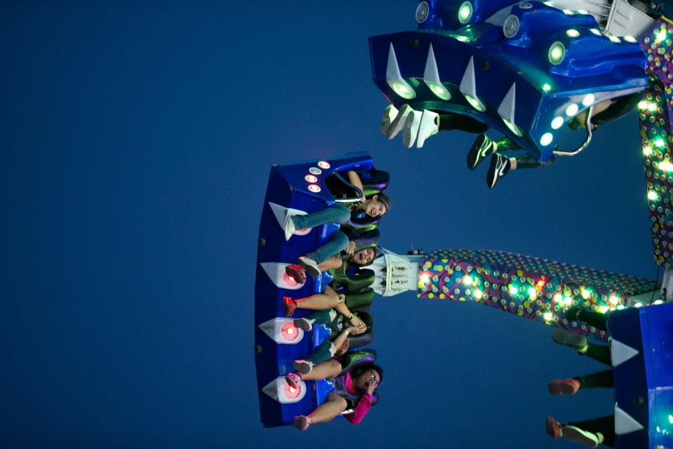 Patrons swing on the Extreme ride at the Stripes Carnival at Buc Days on Friday, May 12, 2023.