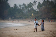 Vistors walk on Ngapali beach in Thandwe, Rakhine State, Myanmar February 19, 2019. REUTERS/Ann Wang