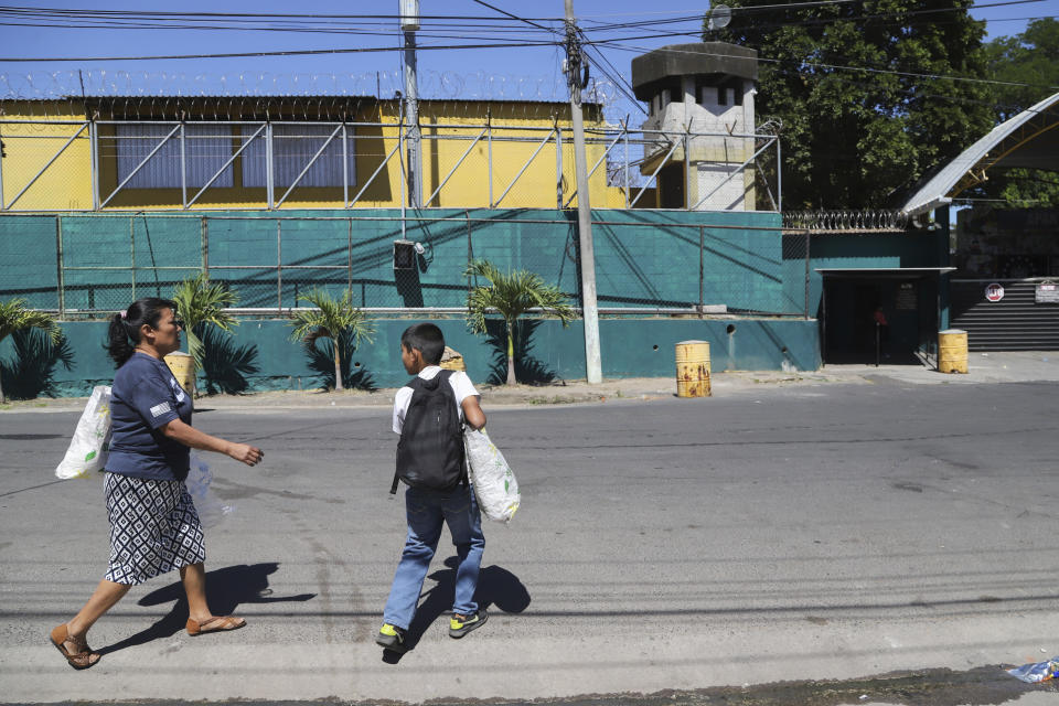 María Concepción Ventura and her 10-year-old grandson, Alex, arrive to the Apanteos women's prison with a care package for her imprisoned daughter and Alex's mother, in Santa Ana, El Salvador, Wednesday, Jan. 31, 2024. Ventura pulls together $75 every few weeks to send fresh clothes, hygiene products and medicine to her daughter, Juana Guadalupe Recinos, who was detained last June during the government's crackdown on its war against drugs. (AP Photo/Salvador Melendez)