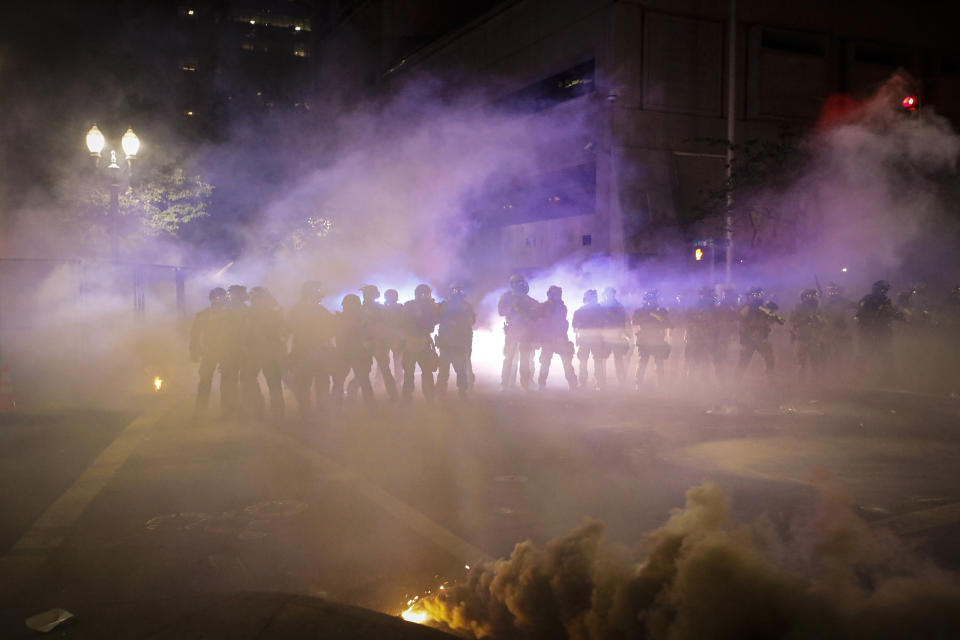 FILE - In this July 24, 2020, file photo federal officers deploy chemical irritants on demonstrators during a Black Lives Matter protest at the Mark O. Hatfield United States Courthouse in Portland, Ore. Beyond the debate over the federal response to protests in Portland, there is the question of whether the Department of Homeland Security, with its specialized national security focus, is the right agency for a job that is traditionally the responsibility local police. (AP Photo/Marcio Jose Sanchez, File)