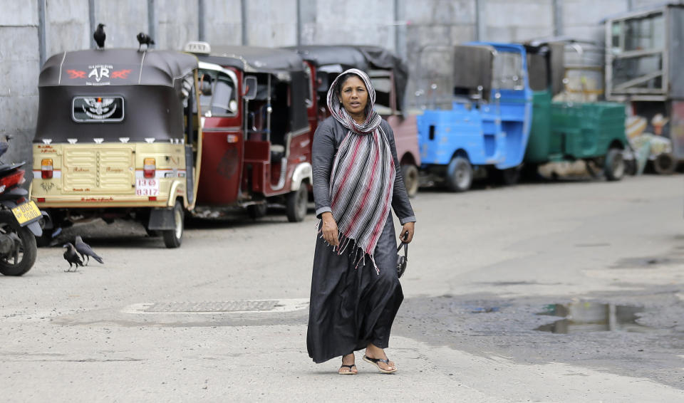 A Sri Lankan Muslim woman walks in a street in Colombo, Sri Lanka, Tuesday, Aug. 27, 2019. Islamic clerics in Sri Lanka asked Muslim women on Tuesday to continue to avoid wearing face veils until the government clarifies whether they are once again allowed now that emergency rule has ended four months after a string of suicide bomb attacks. (AP Photo/Eranga Jayawardena)