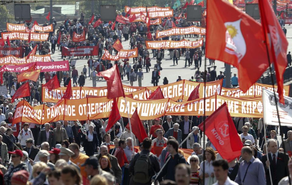 Members of Russia's Communist party carry banners and flags during a May Day rally in Moscow May 1, 2014. Russians celebrate the coming of Spring and since communist times, Labour Day on the first day of May. (REUTERS/Sergei Karpukhin)