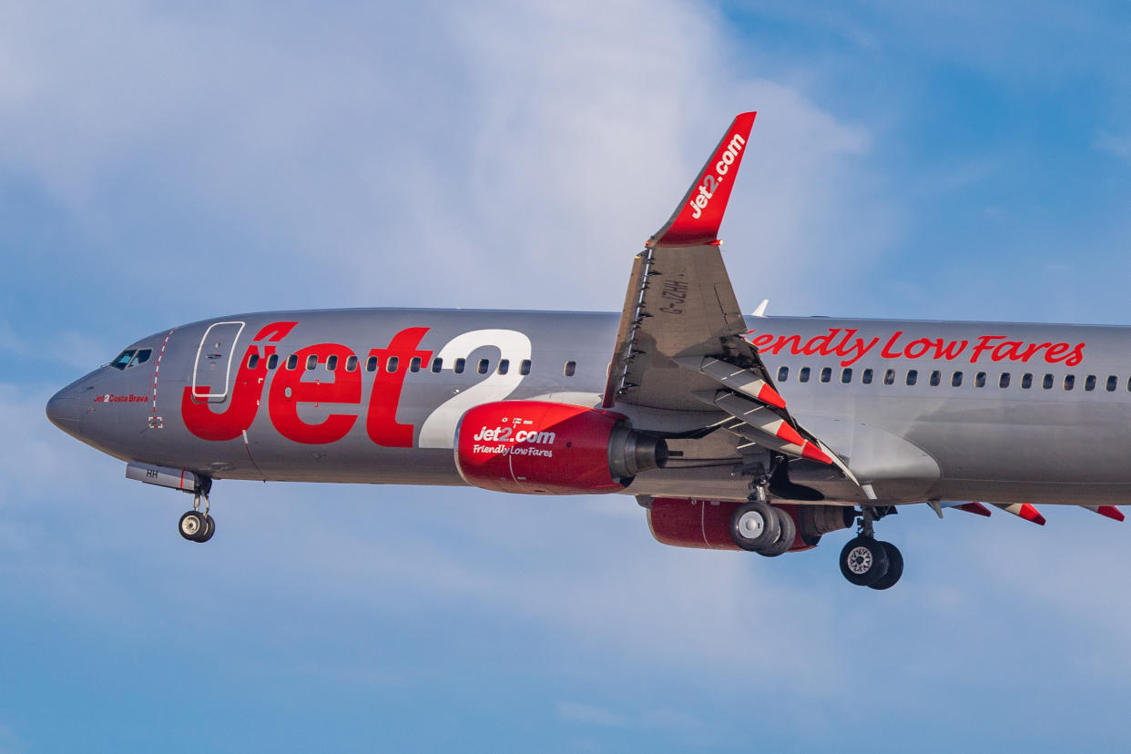 Jet2 or Jet2.com budget airline carrier Boeing 737-800 specifically 737-85P(WL) winglets airplane, with registration G-JZHH and aircraft name Costa Brava, landing at Tenerife South Airport TFS GCTS - Reina Sofia International Airport in Tenerife, Canary Islands, Spain in a blue sky day with clouds. Jet2 LS EXS CHANNEX is a British low cost airline and connects on scheduled and charter flights for holidays Tenerife South with Belfast International, Birmingham, East Midlands, Edinburgh, Glasgow, Leeds Bradford, London Stansted, Manchester and Newcastle. (Photo by Nicolas Economou/NurPhoto via Getty Images)