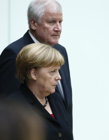 German Chancellor Angela Merkel and Bavarian State Premier Horst Seehofer arrive for a remembrance hour in Bavarian parliament in Munich, Germany, July 31, 2016. REUTERS/Michaela Rehle/Files