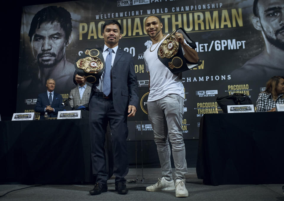 Manny Pacquiao, left, and Keith Thurman pose for a picture during a news conference on Tuesday, May 21, 2019, in New York. The two are scheduled to fight in a welterweight world championship boxing bout on Saturday, July 20, in Las Vegas. (AP Photo/Andres Kudacki)