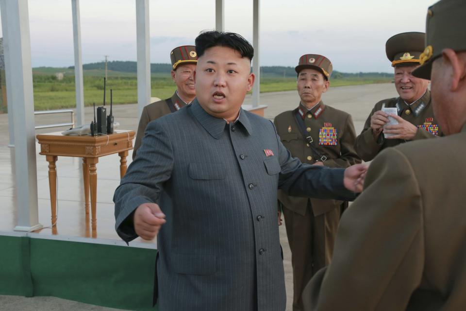 North Korean leader Kim Jong Un (C) guides the actual parachuting and striking drill of paratrooper units of the KPA in this undated photo released by North Korea's Korean Central News Agency (KCNA) August 28, 2014. REUTERS/KCNA (NORTH KOREA - Tags: POLITICS) ATTENTION EDITORS - THIS PICTURE WAS PROVIDED BY A THIRD PARTY. REUTERS IS UNABLE TO INDEPENDENTLY VERIFY THE AUTHENTICITY, CONTENT, LOCATION OR DATE OF THIS IMAGE. FOR EDITORIAL USE ONLY. NOT FOR SALE FOR MARKETING OR ADVERTISING CAMPAIGNS. THIS PICTURE IS DISTRIBUTED EXACTLY AS RECEIVED BY REUTERS, AS A SERVICE TO CLIENTS. NO THIRD PARTY SALES. NOT FOR USE BY REUTERS THIRD PARTY DISTRIBUTORS. SOUTH KOREA OUT. NO COMMERCIAL OR EDITORIAL SALES IN SOUTH KOREA