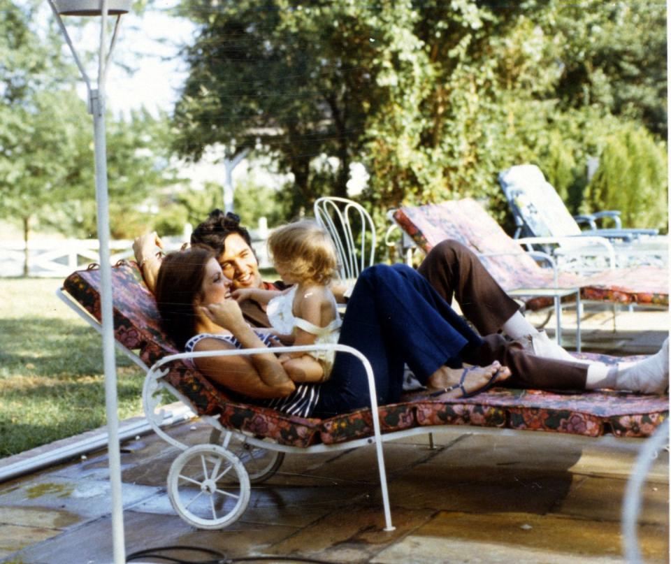 <p>Elvis Presley smiles as he and his wife, Priscilla Presley, play with their daughter Lisa Marie at home in Hawaii, California in 1968. </p>