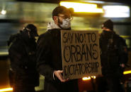 A man protests the policies of Hungarian Prime Minister Viktor Orban during Orban's talks with Poland's Prime Minister Mateusz Morawiecki in Warsaw, Poland, Monday, Nov. 30, 2020. The prime ministers of Poland and Hungary are meeting to discuss their threat to veto the European Union's next budget and massive pandemic aid package that links the disbursement of EU funds to the members' rule of law standards. (AP Photo/Czarek Sokolowski)