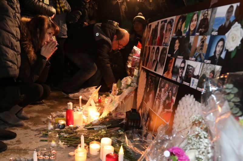 Mourners attend an outdoor vigil for the victims of a Ukrainian passenger jet which crashed in Iran, in Toronto