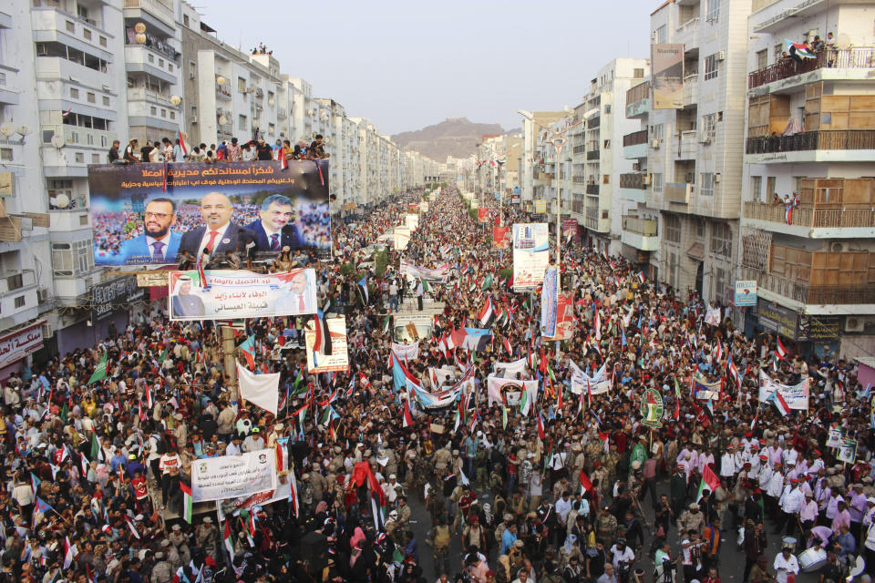 Supporters of southern separatists gather with the flags of south Yemen and the United Arab Emirates during a rally to show support for the UAE amid a standoff with the internationally recognized government, in Aden, Yemen, Thursday, Sept. 05, 2019. Yemeni officials say Saudi Arabia is pushing for a settlement between the internationally recognized government and southern separatists backed by the UAE. They said Thursday that Saudi and UAE officials have met separately to agree on a draft agreement before presenting it to President Abed Rabbo Mansour Hadi and the Southern Transitional Council, which took control of Hadi's interim capital of Aden. (AP Photo/Wail al-Qubaty)