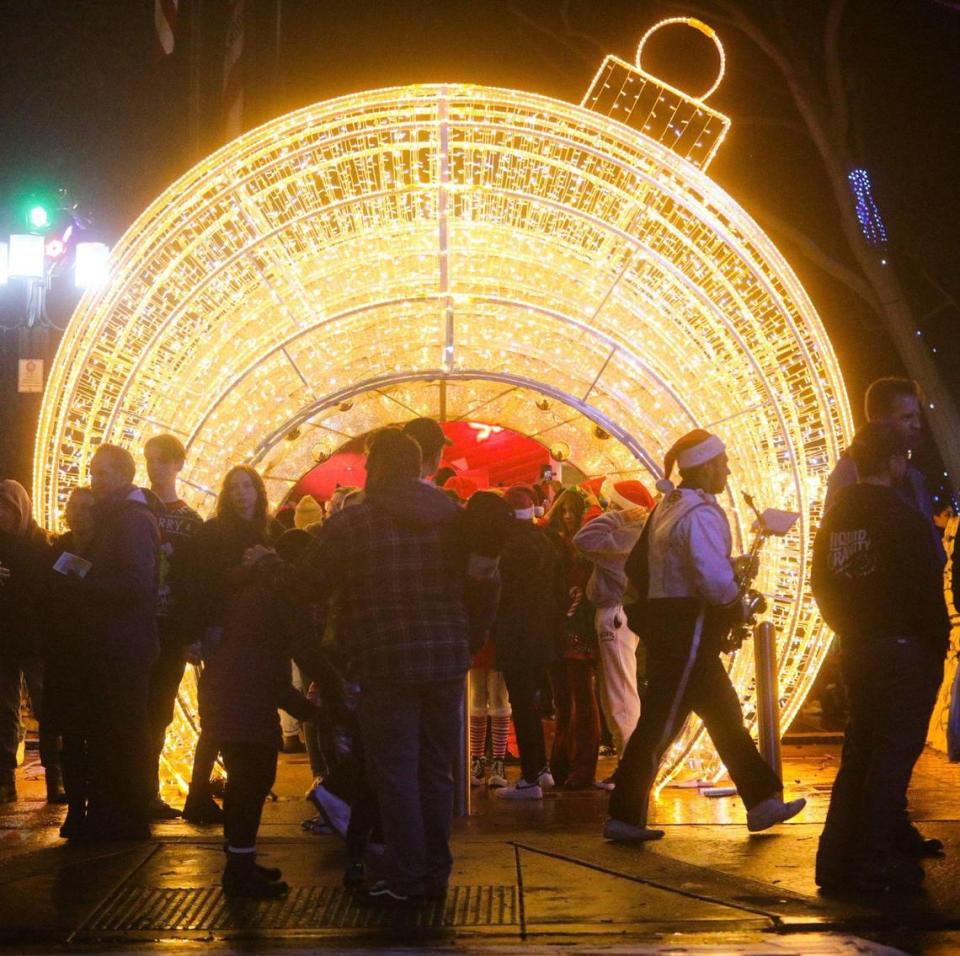 A Cal Poly marching band member walks past Mission Plaza to take position in the parade. The 46th annual Holiday Parade, under the theme “Rockin’ Retro Holidays,” took to the San Luis Obispo streets Dec. 2, 2022.