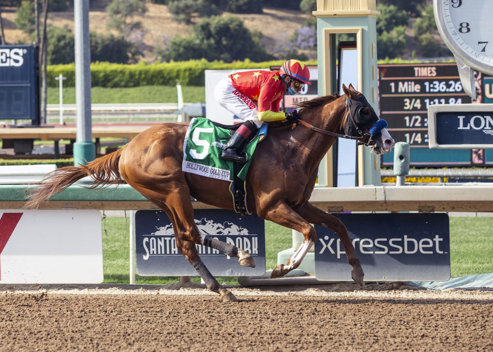 In this image provided by Benoit Photo, Improbable, with Drayden Van Dyke aboard, wins the Grade I $300,000 Hollywood Gold Cup horse race Saturday, June 6, 2020, at Santa Anita Park in Arcadia, Calif. (Benoit Photo via AP)