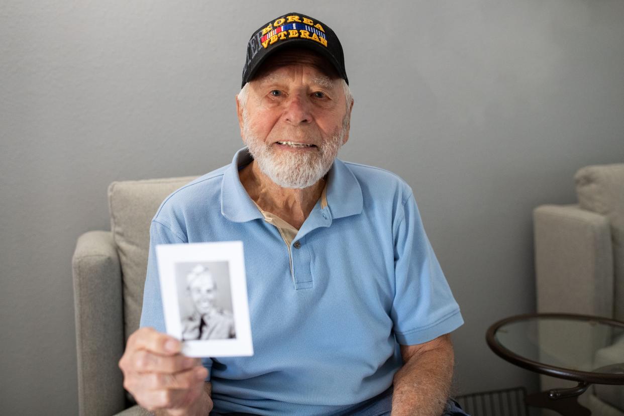 Harold Barcus reminisces on his time serving in the Korean War while looking at old photographs on Wednesday, April 10, 2024.