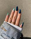 This moody emerald green marble mani is just <em>begging</em> to be photographed holding a PSL.