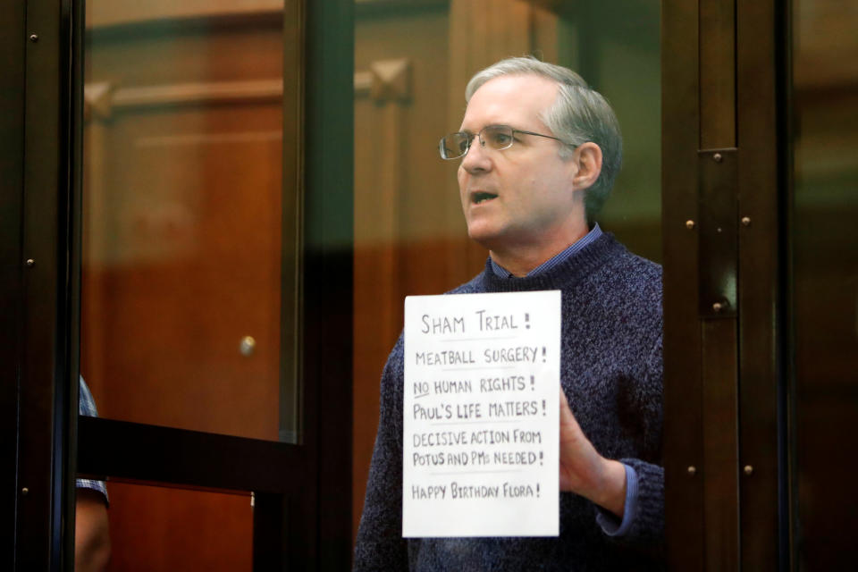 Former U.S. Marine Paul Whelan holds a sign declaring 