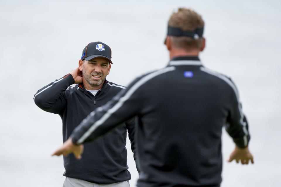 Team Europe's Sergio Garcia talks to Team Europe's Ian Poulter on the sixth hole during a practice day at the Ryder Cup at the Whistling Straits Golf Course Thursday, Sept. 23, 2021, in Sheboygan, Wis. (AP Photo/Charlie Neibergall)