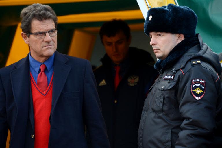 Fabio Capello (left) awaits the start of a friendly between Russia and Armenia in Krasnodar on March 5, 2014