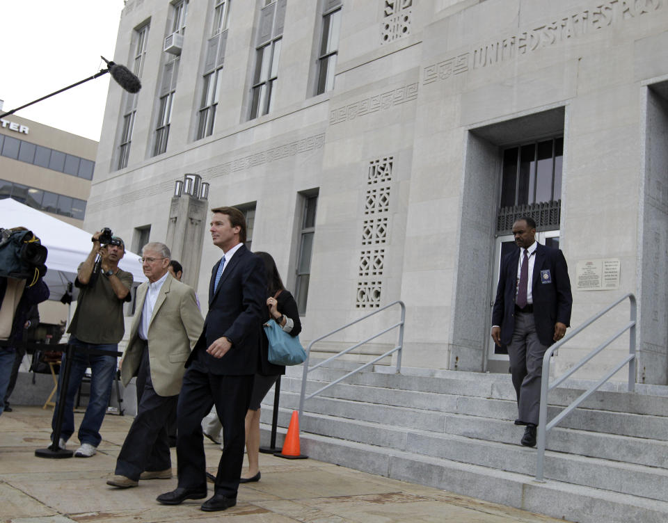 Former presidential candidate and Sen. John Edwards, center, leaves a federal courthouse in Greensboro, N.C., Tuesday, May 8, 2012. Edwards is accused of conspiring to secretly obtain more than $900,000 from two wealthy supporters to hide his extramarital affair with Rielle Hunter and her pregnancy. He has pleaded not guilty to six charges related to violations of campaign-finance laws. (AP Photo/Chuck Burton)