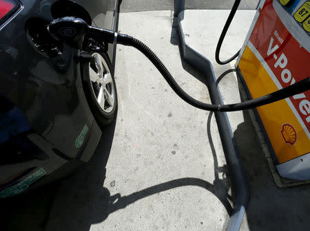 FILE PHOTO: A car is filled with gasoline at a gas station pump in Carlsbad, California August 4, 2015. REUTERS/Mike Blake/File Photo