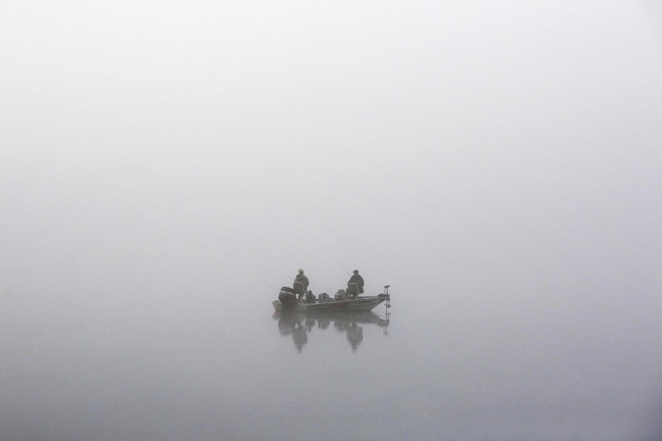 <p>Men fish in the dense, early-morning fog on Cheshire Lake in Cheshire, Mass., May 20, 2016. (Stephanie Zollshan/The Berkshire Eagle via AP) </p>