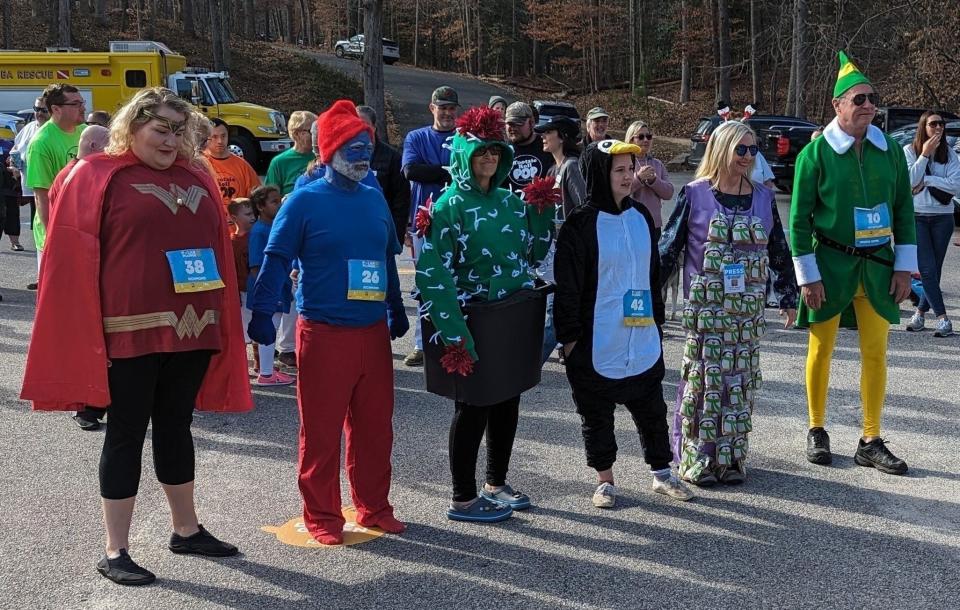 Contestants line up at the 2024 Richmond Polar Plunge to be judged. Second from the right, Kristi K. Higgins takes first place for best-dressed plunger. Second from the left, Kevin McCurdy wins people's choice best costume award.