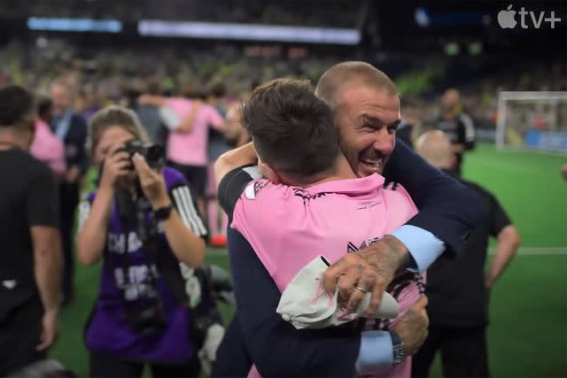 <p>Courtesy of Apple TV+</p> David Beckham and Lionel Messi hug in the trailer for 'Messi Meets America.'