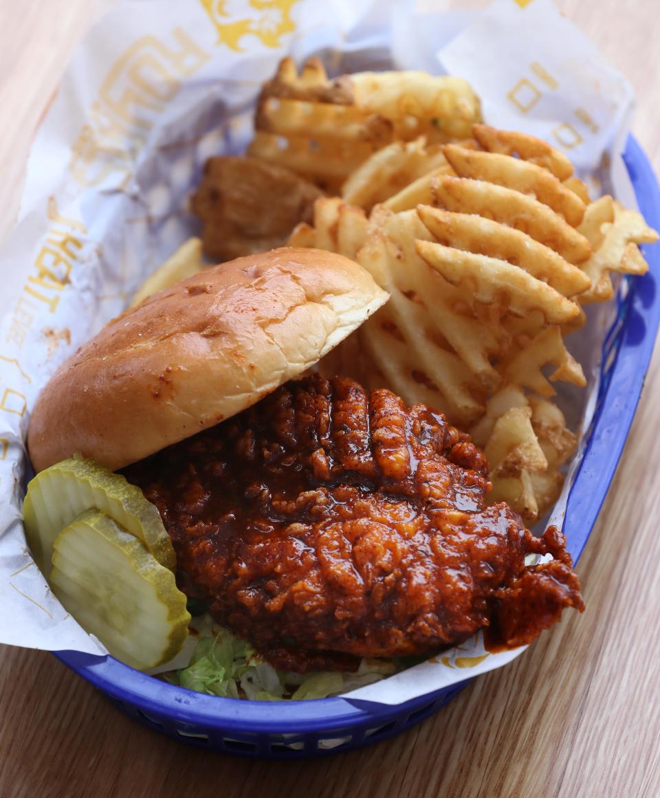 Royals Classic Fried Chicken Sandwich with Some Heat Sauce and waffle fries served at Royals Hot Chicken in Jeffersontown, Ky. on Feb. 17, 2020.  