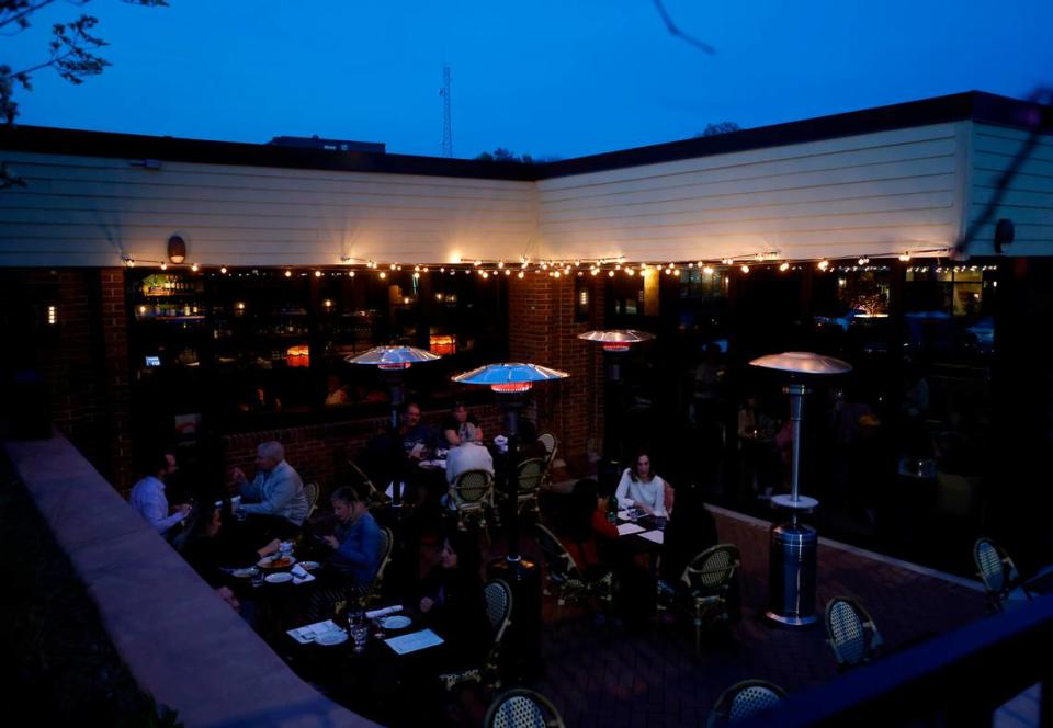 Patrons dine on the patio at Hank’s Downtown Dive on Thursday, March 16, 2023, in Cary, N.C.