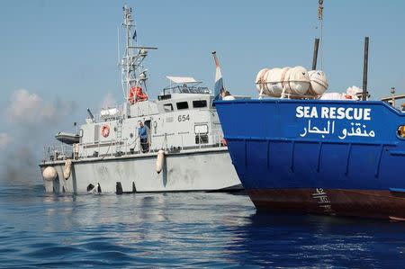 A Libyan coast guard vessel is seen next to the Mission Lifeline rescue boat in the central Mediterranean Sea, June 21, 2018. Picture taken June 21, 2018. Hermine Poschmann/Misson-Lifeline/Handout via REUTERS