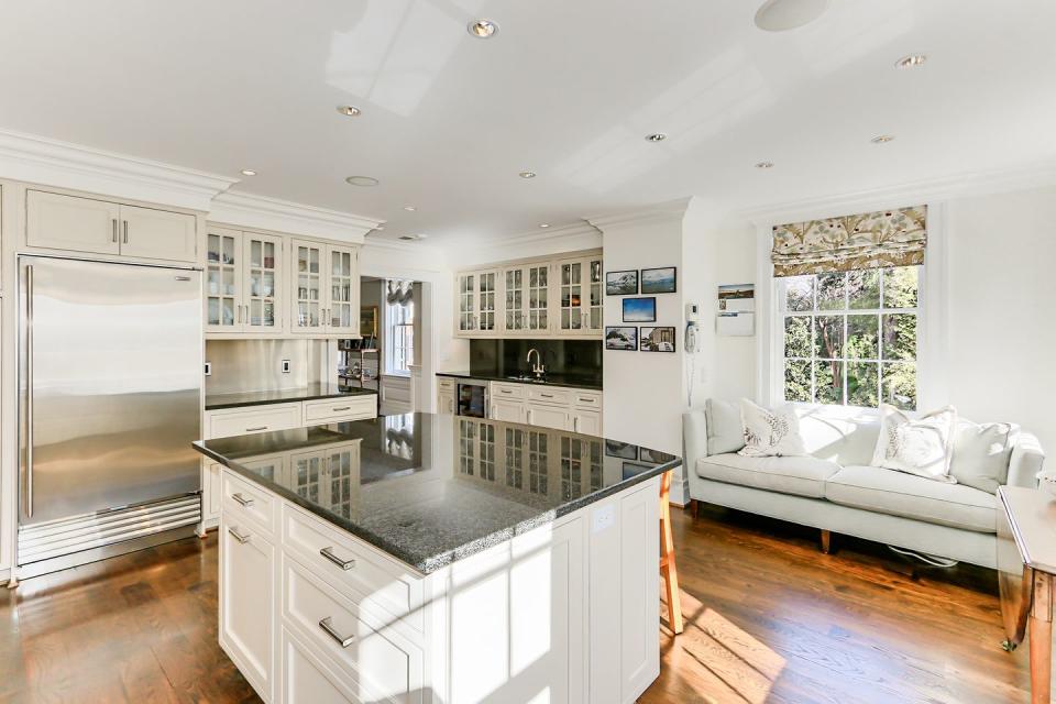 The kitchen features high-tech appliances and a breakfast bar.