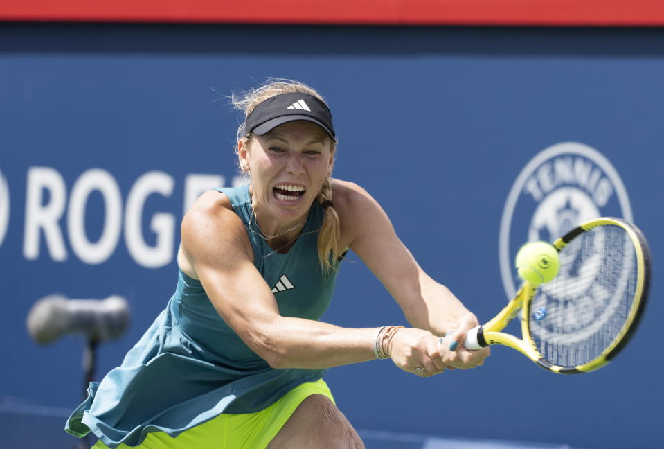 Caroline Wozniacki of Denmark, hits a return against Kimberly Birrell, of Australia, during the National Bank Open women's tennis tournament in Montreal, Tuesday, Aug. 8, 2023. (Christinne Muschi/The Canadian Press via AP)