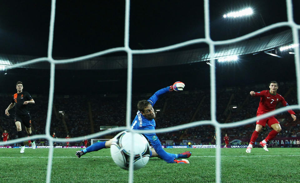 KHARKOV, UKRAINE - JUNE 17: Cristiano Ronaldo of Portugal scores his team's second goal past Maarten Stekelenburg of Netherlands during the UEFA EURO 2012 group B match between Portugal and Netherlands at Metalist Stadium on June 17, 2012 in Kharkov, Ukraine. (Photo by Ian Walton/Getty Images)