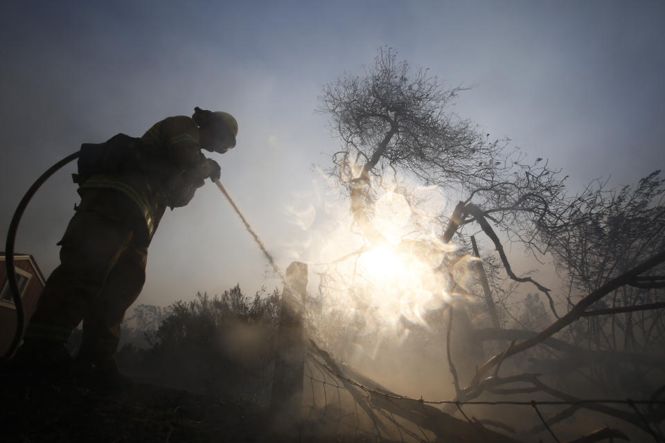 A firefighter battles a wildfire near a ranch in Simi Valley, Calif., Oct. 30, 2019.  A large new wildfire has erupted in wind-whipped Southern California, forcing the evacuation of the Ronald Reagan Presidential Library and nearby homes.  (Photo: Ringo H.W. Chiu/AP)